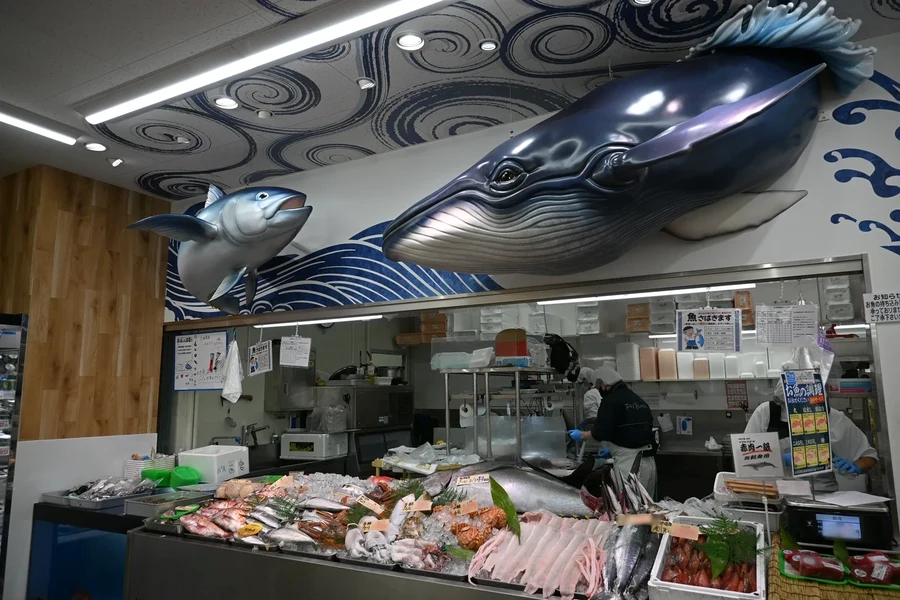 西宮店の水産売場。鯨とお魚の造形、波の壁画と対面ケースが見える写真