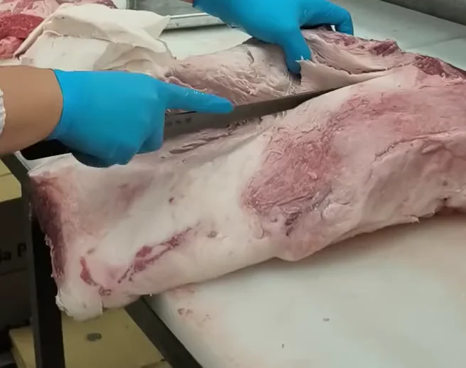 肉を切り分けるスタッフの手元